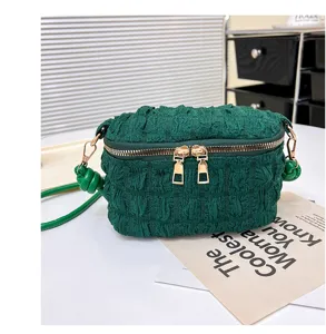 Green textured mini crossbody bag with zipper closure and stylish cloud design for women.