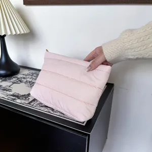 Chic pink quilted clutch bag for women, minimalist style puffer pouch for daily commute and evening party.