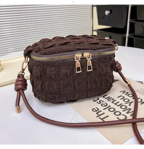 Mini brown pleated puffer crossbody bag with dual gold zippers and stylish shoulder strap.