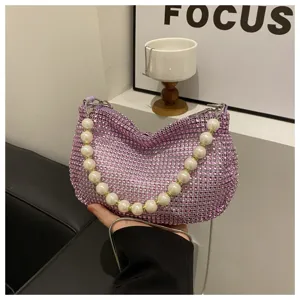 Detailed view of the sparkling rhinestone evening shoulder bag with a luxury pearl handle.