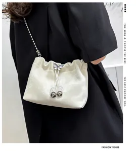 Chic plush bucket bag with pearl butterfly charm and metal chain strap for daily fashion.