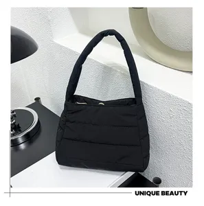 Detailed view of black quilted nylon shoulder bag, lightweight casual underarm bag design.