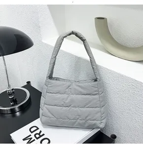 Close-up detail of the stylish quilted nylon shoulder bag, showing soft texture and stitching.