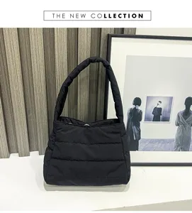 Black quilted nylon shoulder bag detail view, casual soft lightweight underarm handbag.