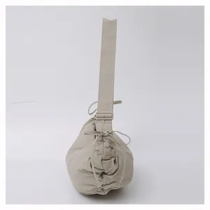 Detail view of the beige pleated nylon dumpling shoulder bag, showing side drawstring style.