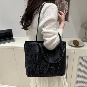 Black crinkled tote bag detail, stylish women's shoulder bag for daily commute and casual wear.