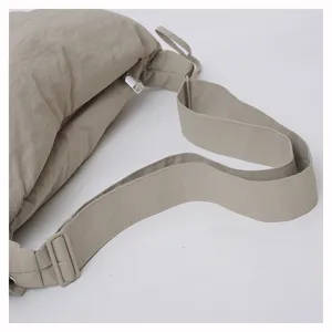 Detailed view of casual nylon crossbody dumpling bag strap and zipper, lightweight and versatile.
