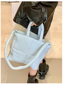 Padded quilted tote bag featuring double handles and long strap, soft cloud handbag for daily use.