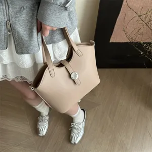 Detailansicht einer schicken beigen PU-Leder Eimertasche mit Metallverschluss, Handtasche.