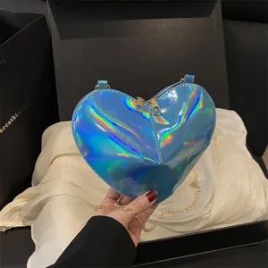Trendy glossy heart-shaped crossbody bag detail, cute metallic chain mini shoulder bag for women.