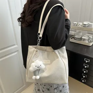 Detail view of stylish women tote bag with cute cloud charm, large capacity design for daily use.