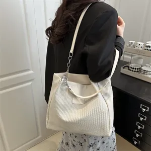 White corduroy tote bag for women, stylish shoulder bag with chain strap and large capacity.