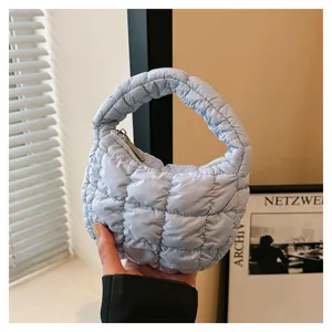 Light blue quilted cloud handbag, stylish mini puffer tote bag for women daily fashion.