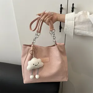 Pink canvas shoulder tote bag with chain strap and cute cloud charm for women commuter use.