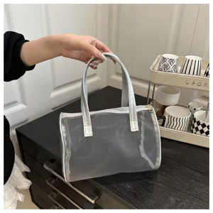 Transparent mesh cylinder handbag detail view, portable silver trim jelly tote bag style.