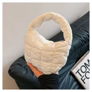 White quilted puffer mini handbag, trendy cloud underarm bag close up detail view.