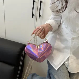 Detailed close-up view of the pink holographic heart-shaped mini shoulder bag with chain.
