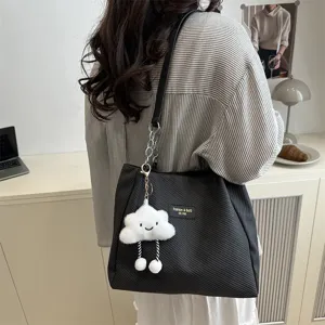 Stylish black shoulder tote bag with cloud pendant, large capacity daily commuter bag.
