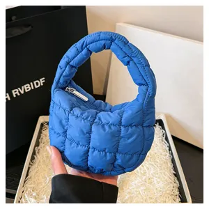 Blue quilted cloud handbag, stylish mini puffer tote bag with zipper for women daily fashion.