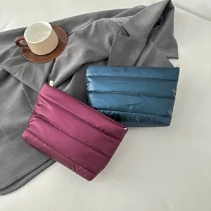 Puffer quilted cosmetic bag detail view, soft nylon material, convenient daily zipper pouch.