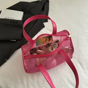 Transparent pink PVC jelly handbag with large capacity, portable shoulder tote cosmetic bag.