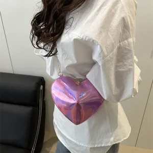Close-up detail of a shiny holographic heart-shaped crossbody bag worn by a model, trendy.