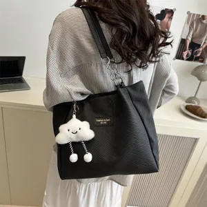 Casual black tote bag with cloud charm, stylish large capacity shoulder bag for daily commute.
