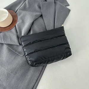 Black quilted clutch bag minimalist cosmetic pouch soft padded daily storage zip purse chic accessory.