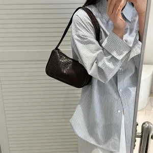 Stylish brown woven underarm shoulder bag, premium leather texture, chic everyday accessory.