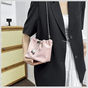 Chic pink velvet chain bucket bag detailed view, elegant women's crossbody shoulder bag.