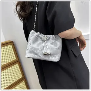 Silver grey velvet bucket bag with chain strap and cute butterfly drawstring charm for women.
