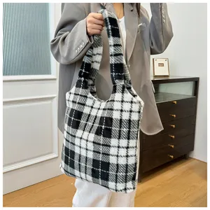 Detail view of the fuzzy black and white plaid tote bag featuring soft plush material and large capacity.