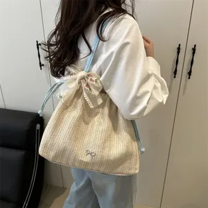 Woven straw shoulder bag for women, large capacity stylish tote with delicate lace bow.