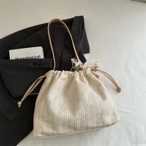 Straw shoulder bag for women, stylish large capacity tote with scarf and leather straps.