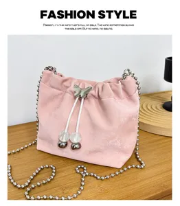 Pink velvet bucket bag with metal chain strap and cute butterfly drawstring detail.