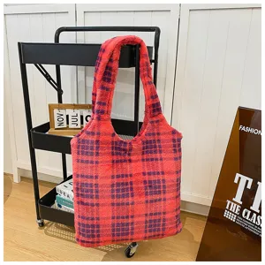 Detailed view of fluffy red plaid tote bag, soft winter shoulder bag in cozy lifestyle setting.