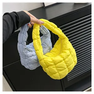Mini puffer cloud handbag with pleated design, soft quilted material and zipper closure.
