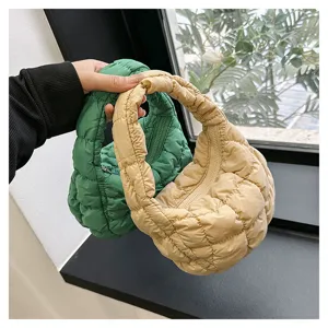 Detailed view of the trendy quilted puffer cloud handbag, showcasing soft pleated texture and zipper.