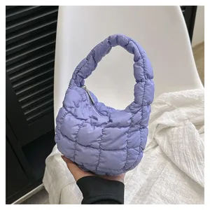Detailed view of the trendy purple quilted puffer cloud bag, featuring a soft chic mini design.
