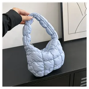 Light blue quilted cloud bag detail showcasing soft puffy fabric texture and gathered strap.