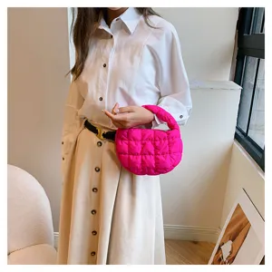 Stylish pink quilted cloud handbag detail showing texture, strap and puffy mini design.