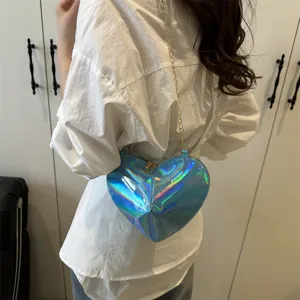 Detailed view of the trendy heart-shaped patent leather shoulder bag in glossy blue finish.