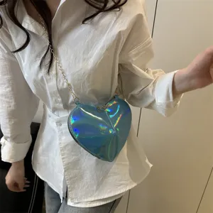 Detail view of a stylish holographic heart-shaped crossbody bag with chain strap for women