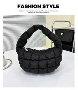 Detailed view of black quilted puffer cloud handbag, trendy mini underarm bag design.