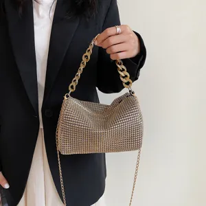 Detailed close-up view of the sparkling rhinestone evening handbag featuring chunky gold chain.