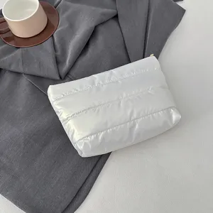 Minimalist white quilted clutch bag, soft padded cosmetic pouch for daily stylish women.