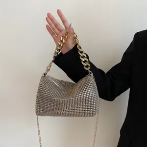 Rhinestone evening bag detail showing sparkly crystals and chunky gold chain strap design.