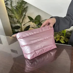 Pink quilted clutch bag detail view, soft puffer makeup bag for women, stylish daily use.