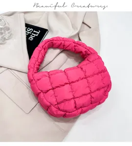 Close-up of trendy hot pink quilted puffy cloud bag, showcasing soft fabric and chic design.