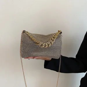 Rhinestone evening bag detail, sparkling crystal clutch with chic gold chain strap for women.